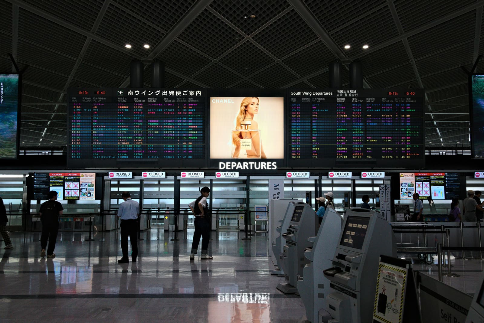Departure boards and check-in counters at a major Japan gateway airport